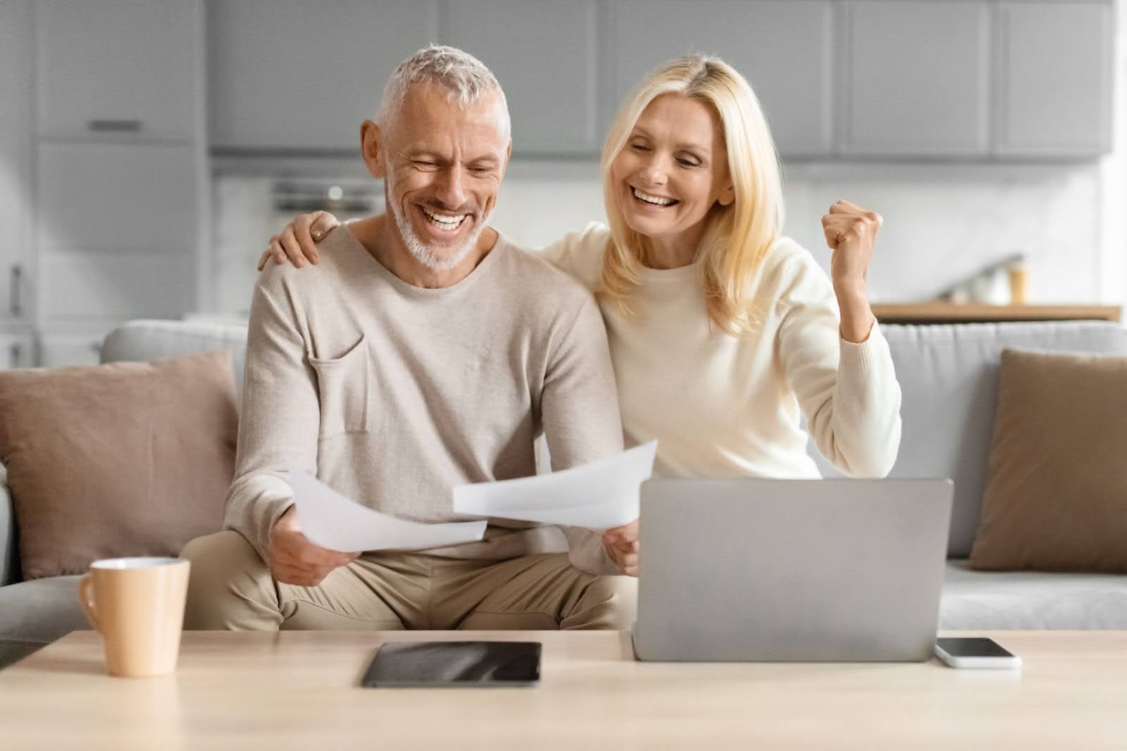 Older couple looking happy while working from home together