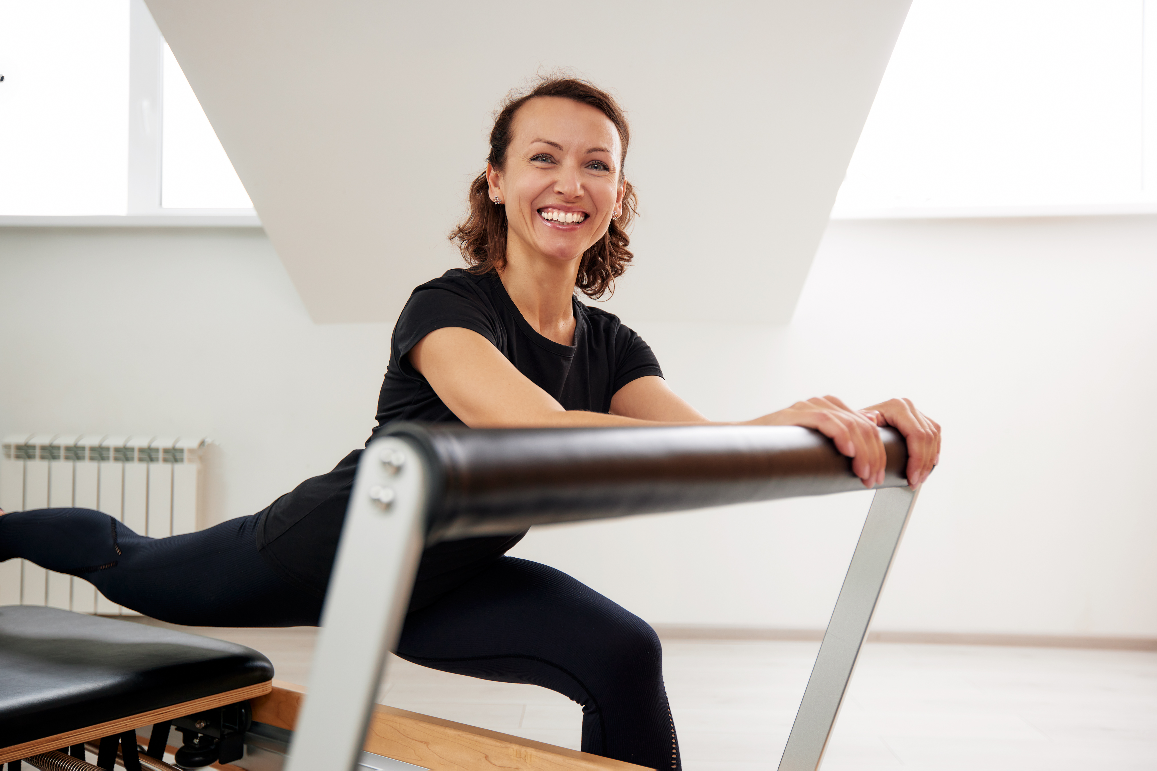 Women doing Pilates on a reformer machine.