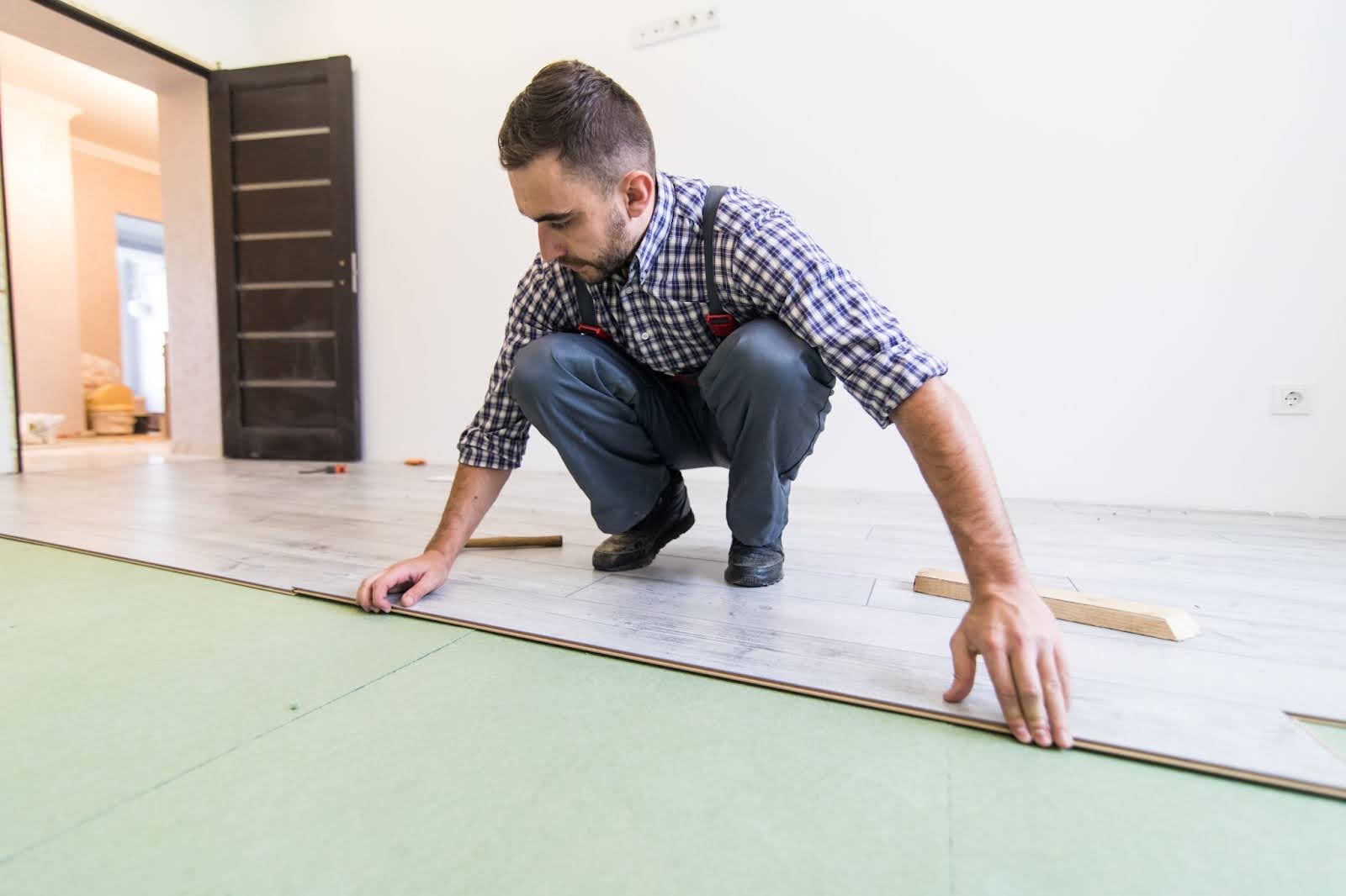 Man at work measuring flooring